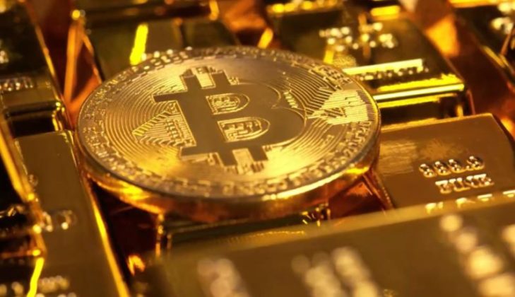 BTC Bitcoin lying flat on gold bars valued in New Zealand Dollars