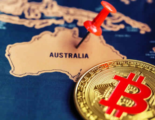 Bitcoin (BTC) is illustrated as physical coin laying on a map and a push pin is nailed on Australia area