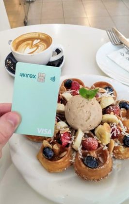 A person is using Wirex cryptocurrency card to buy food and beverages