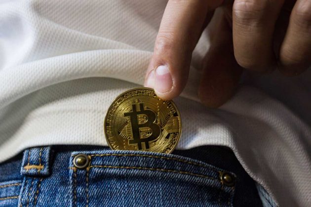 Physical Bitcoin shoved into a pocket to illustrate Cryptocurrency succession plan