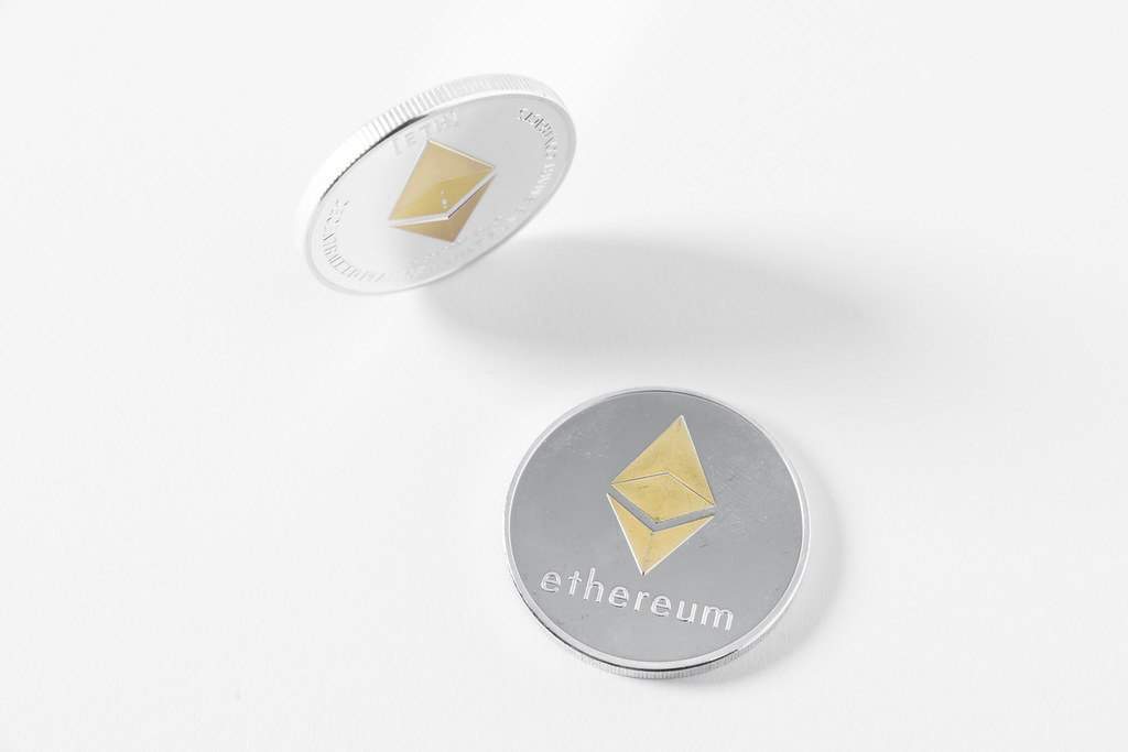 Bitcoins and Ethereum tokens are illustrated as physical coins