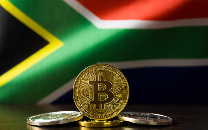 Bitcoin (BTC) is illustrated as physical gold coins with the national flag of South Africa on the bakcground