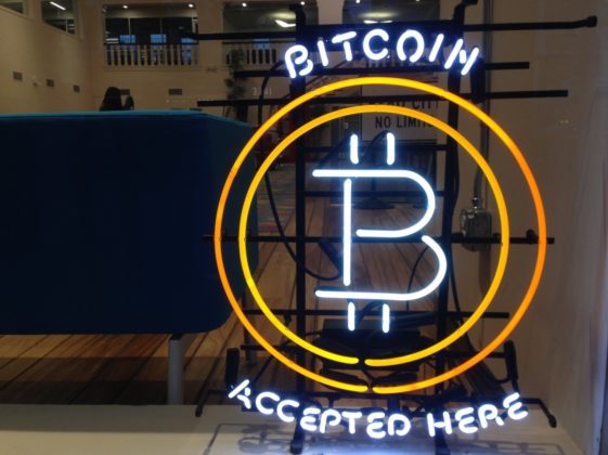 The sign of a place that accepts cryptocurrency payments in New Zealand to illustrate the idea to buy with crypto