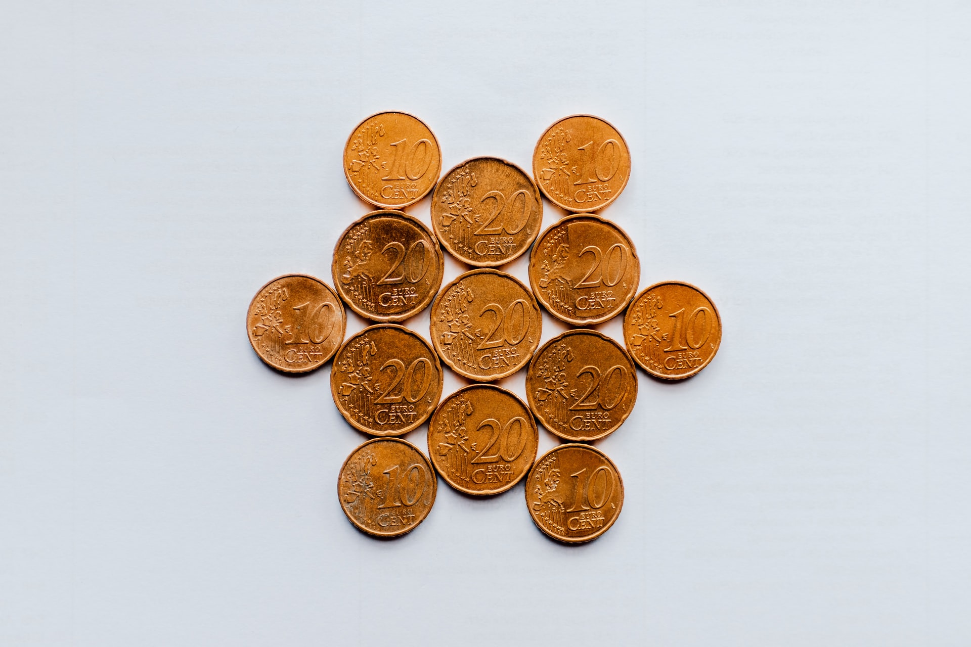 Photo of coins on a white background to illustrate the idea of is bitcoin money.