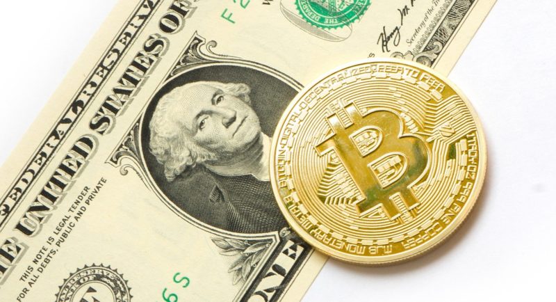 Bitcoin-BTC-on-top-of-USD-Bank-note-with-white-back-ground
