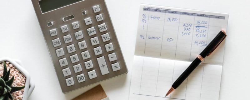 filing-your-cryptocurrency-tax-in-on-paper-with-a-calculator-and-pen