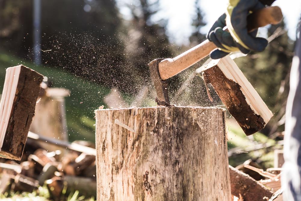 Man chopping wood in half with an axe