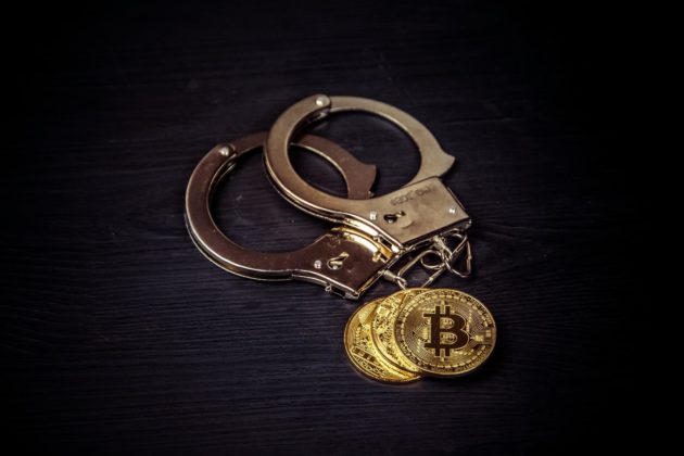 Bitcoins and handcuffs to illustrate if bitcoin is legal in Nigeria