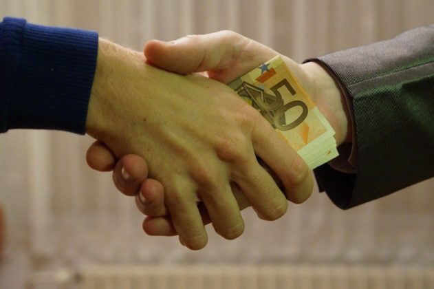 Close up shot of a handshake to illustrate choosing a secure crypto exchange to work with