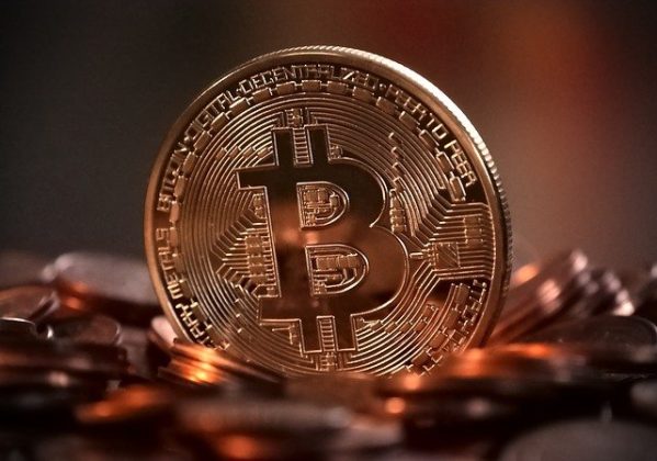 Image of a bitcoin surrounded by other reflective coins