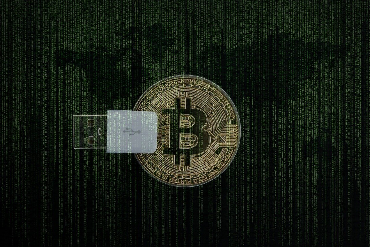 An image of golden bitcoin overlayed by a green matrix