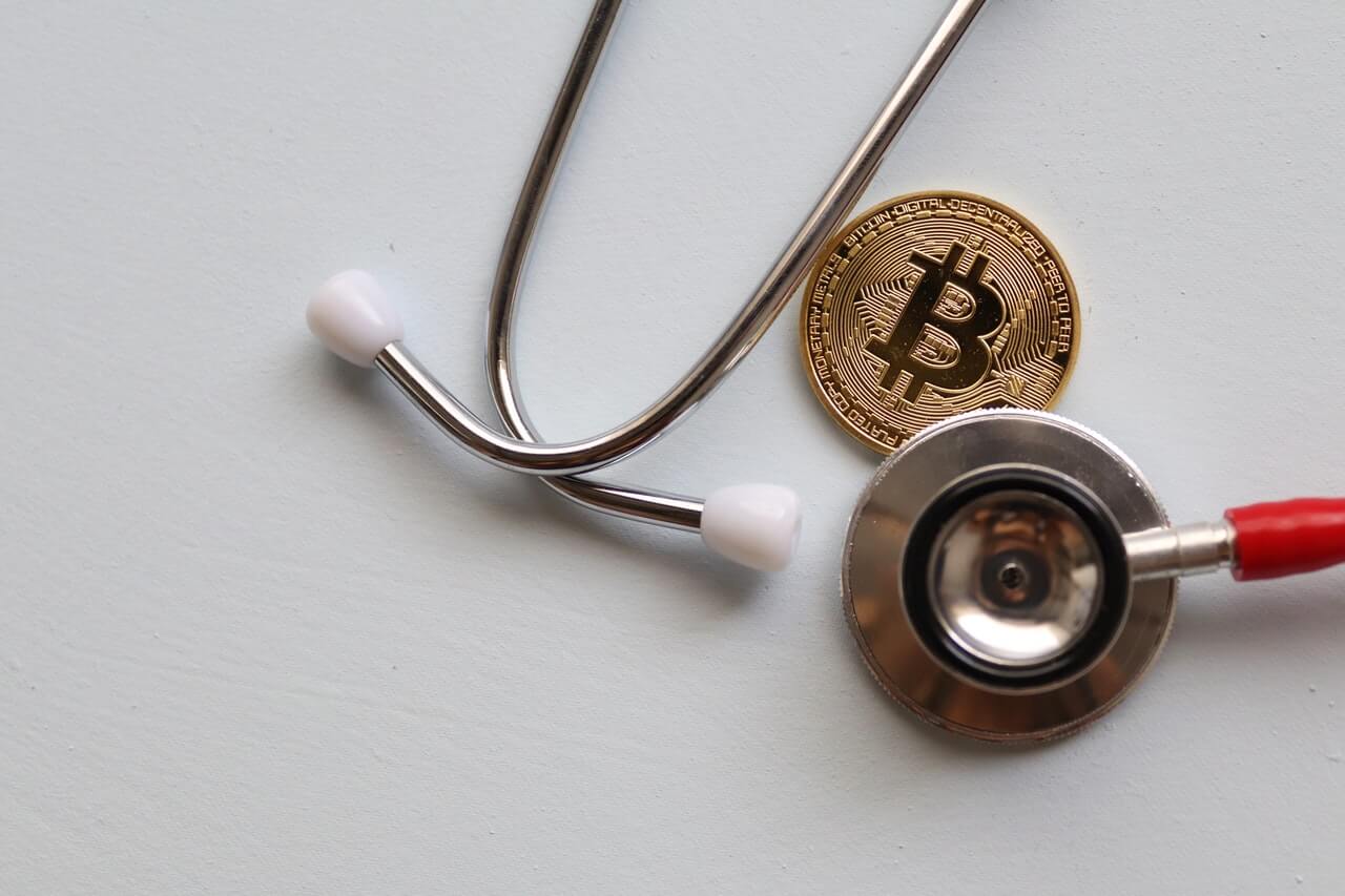 Bitcoin with stethoscope on a white background