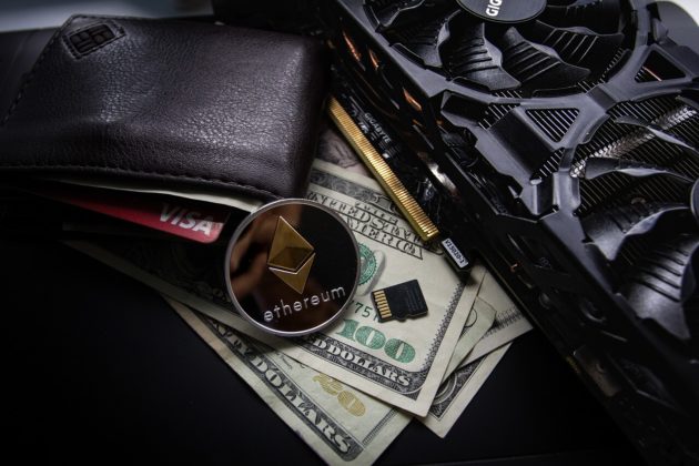 Ethereum coin on top of a desk surrounded USD and wallet