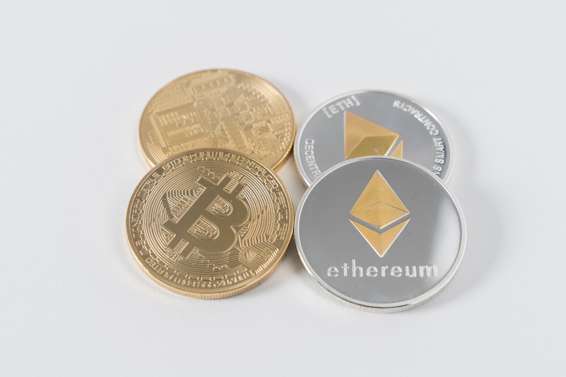 Image of two bitcoins next to two ethereum coins to illustrate the idea of what is ethereum and its differences to bitcoin.