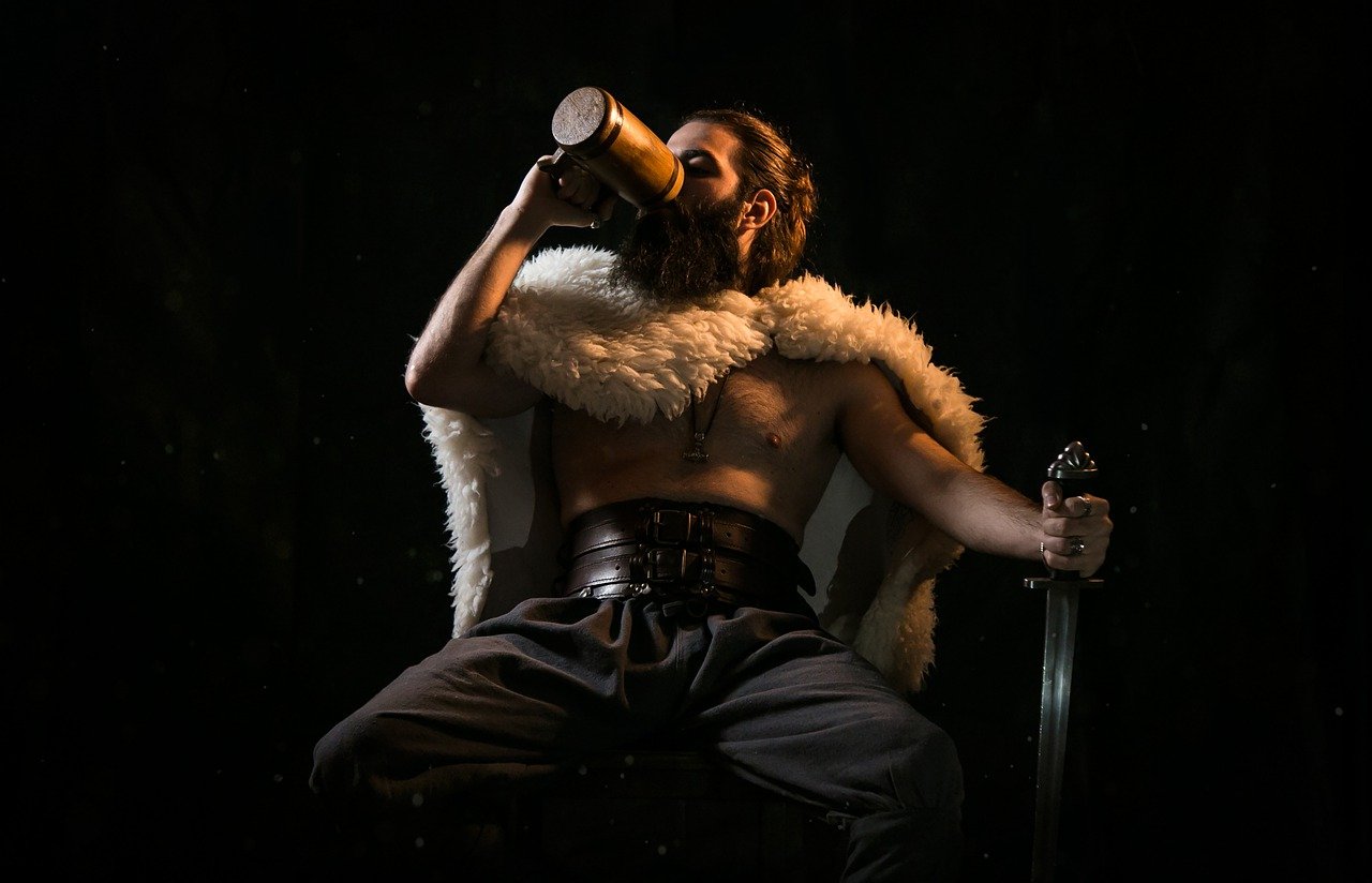 Game character sitting and drinking ale.