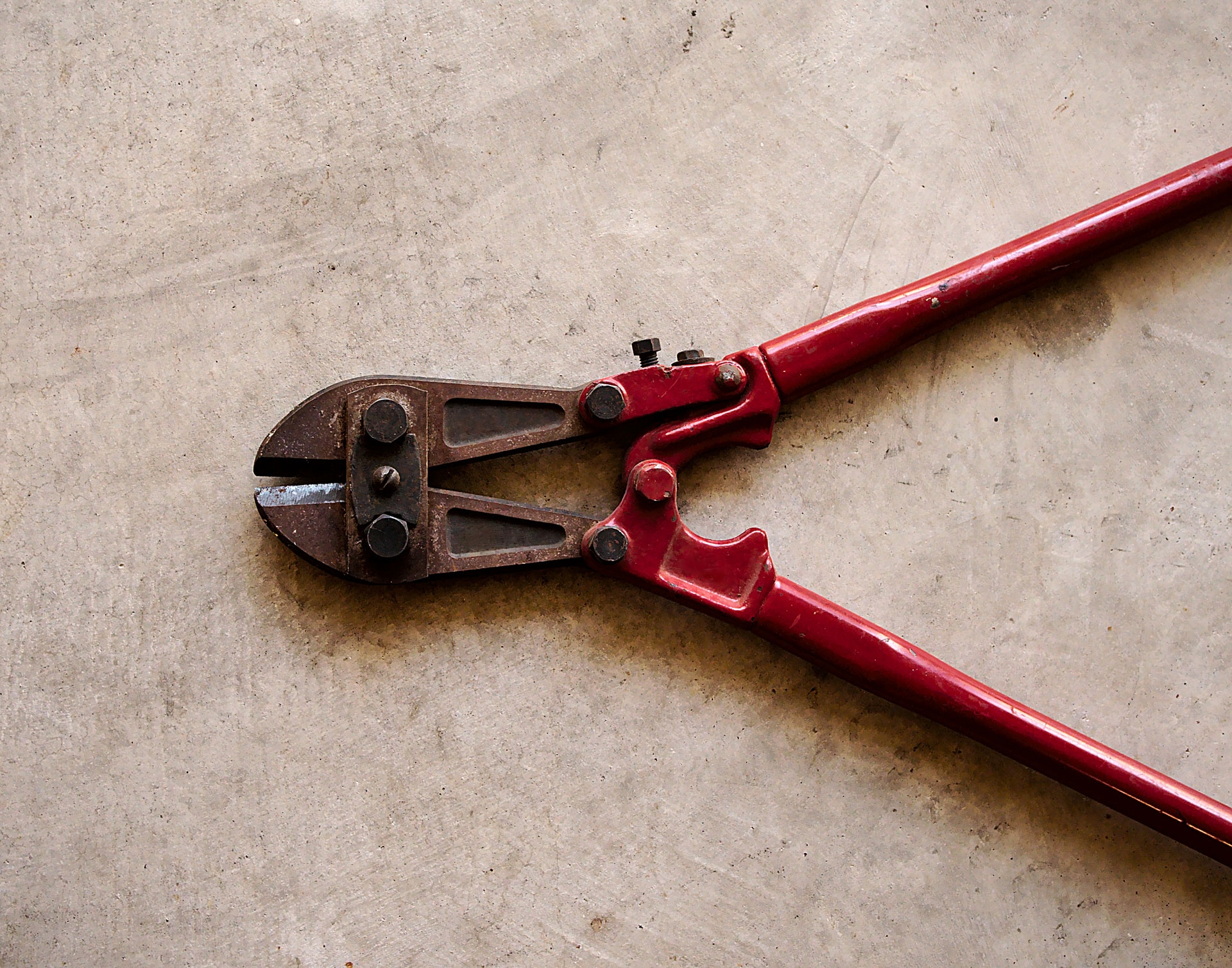 A wrench with red handles.