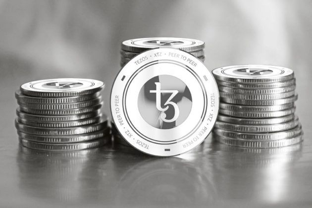 Photo of physical Tezos (XTZ) coins in black and white.