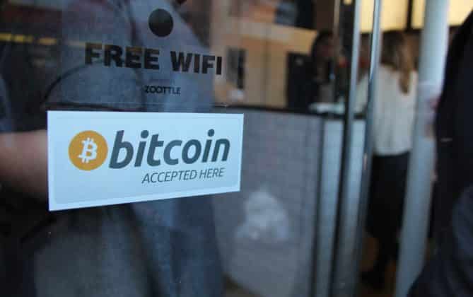 A sign that tells Bitcoin is accepted as a payment method