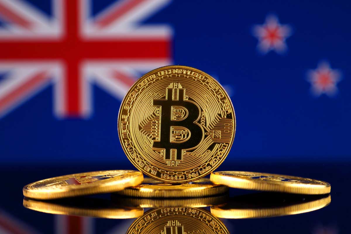 Golden BTC Bitcoin in front of New Zealand NZ flag