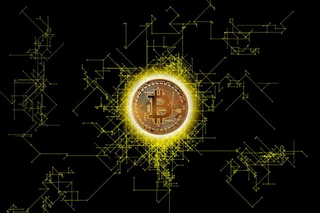 Image of a bitcoin logo backdropped by a black and gold background.
