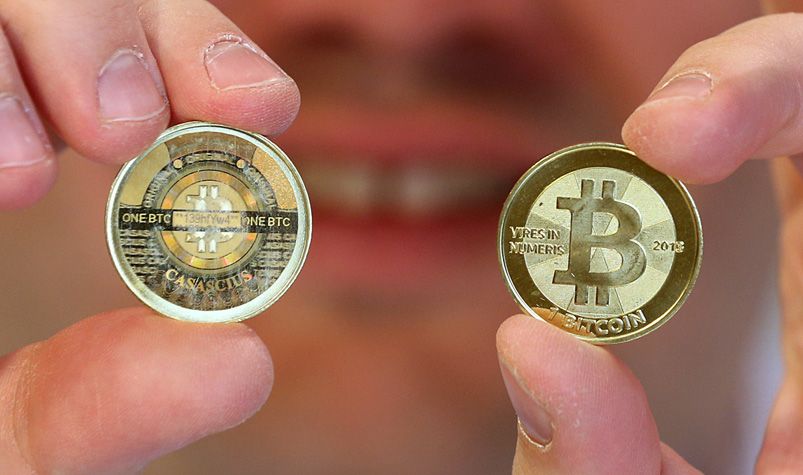 bitcoin held by fingers