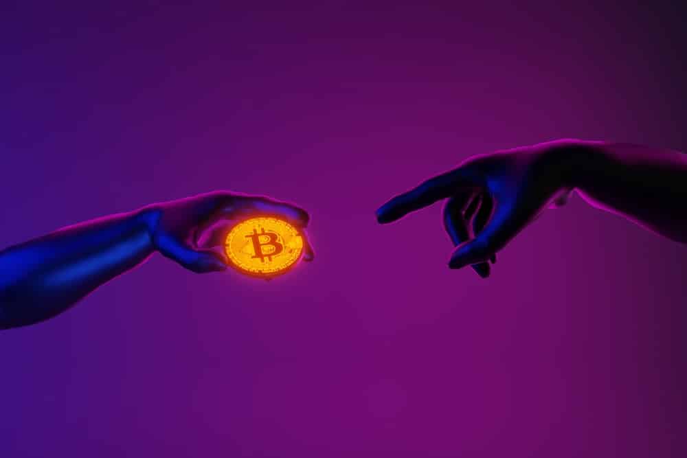 Two hands reaching out to Bitcoin