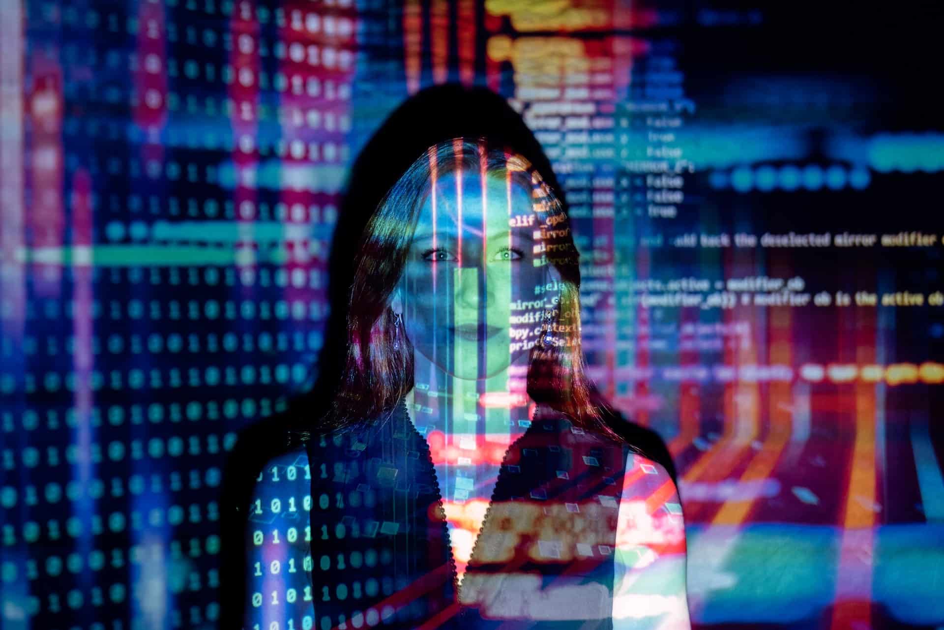 Photo of a woman with a coding projected over her body.