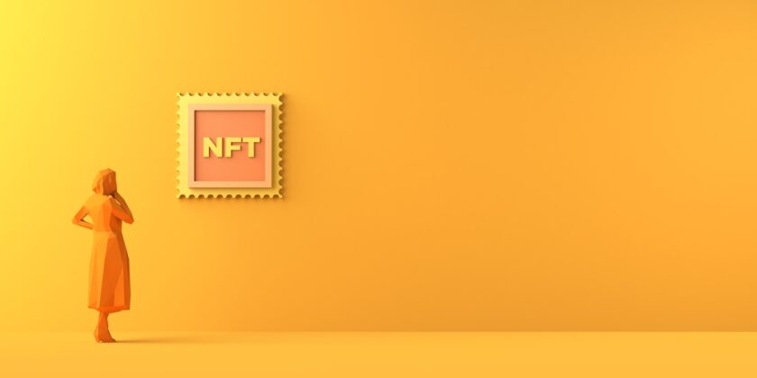 Person looking at an NFT on orange background